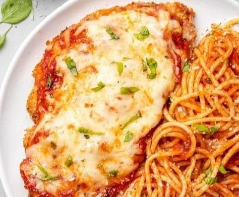 Delicious baked chicken parmesan served with a side of fresh greens