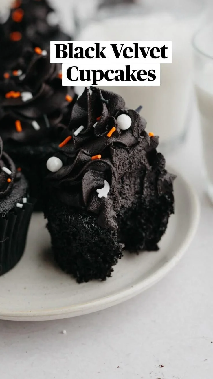 Decadent black velvet cupcakes topped with creamy frosting.