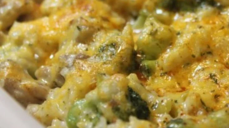 Cheesy broccoli chicken casserole with rice in a baking dish