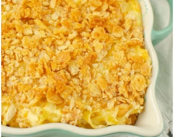 Cheesy Chicken Noodle Casserole served in a baking dish with garnished parsley.