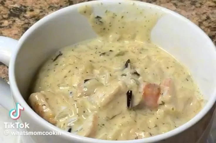 Bowl of chicken and wild rice soup with herbs and vegetables