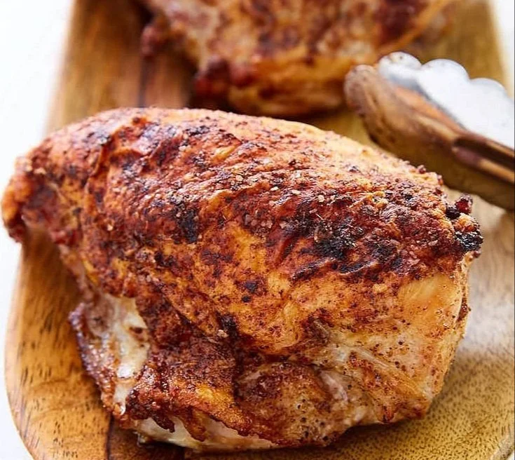 Crispy oven roasted chicken breast plated with herbs and spices
