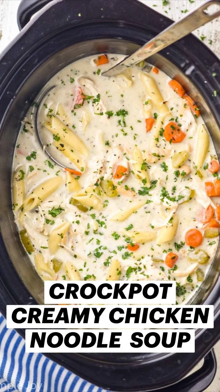Creamy chicken noodle soup made in a crockpot, garnished with herbs