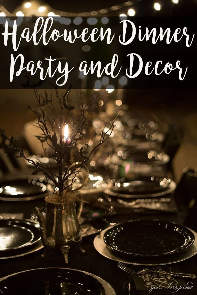 Elegant Halloween dinner party table setting with themed decor and candles.