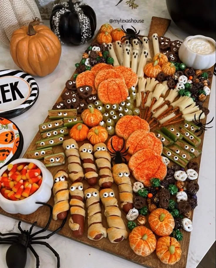 Colorful Halloween food board featuring spooky snacks and treats