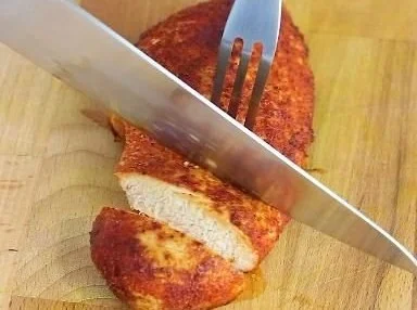 Juicy perfect baked chicken breast served with herbs and spices