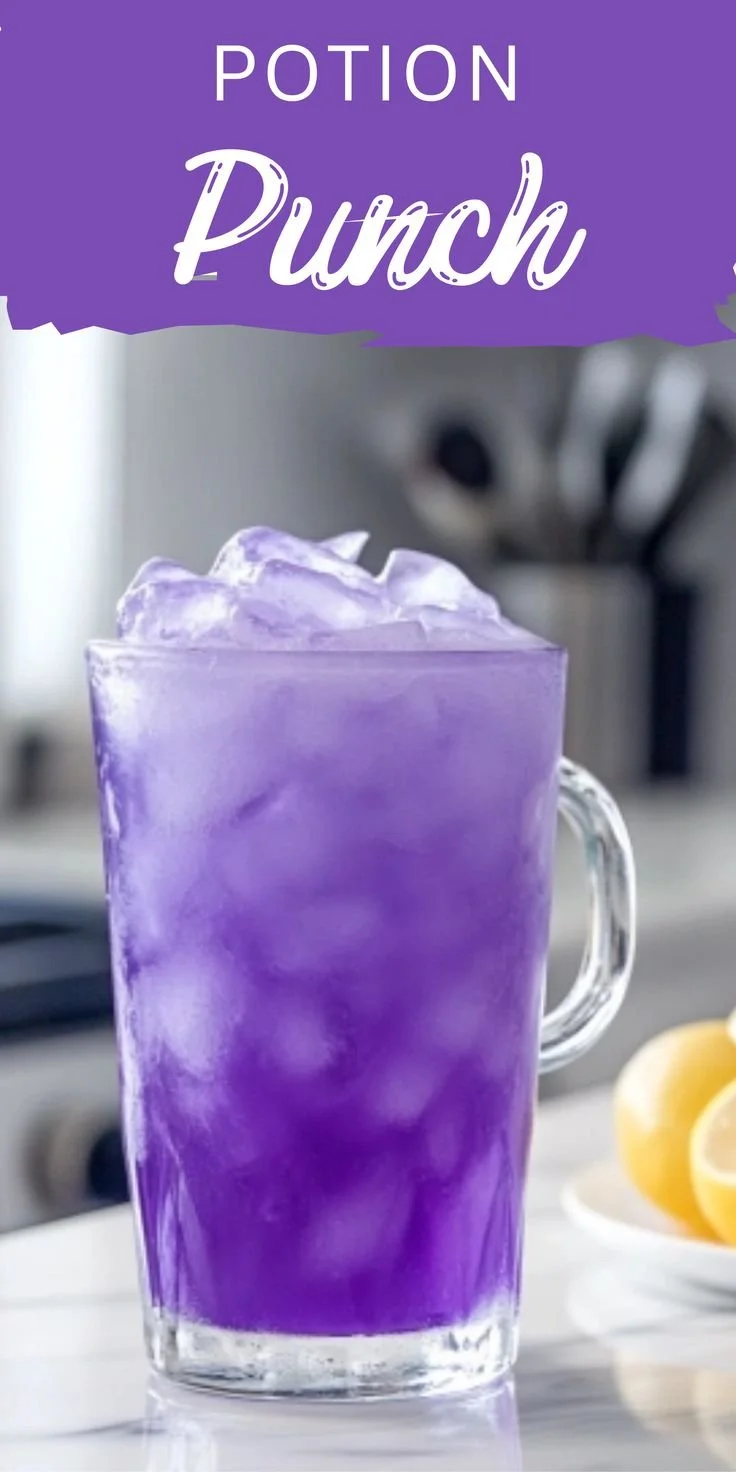 Colorful potion punch served in a glass with magical fruit garnishes.