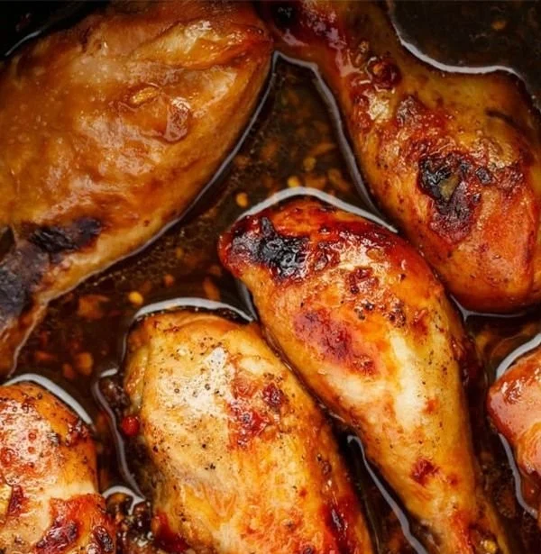 Delicious slow cooker Asian chicken drumsticks garnished with green onions