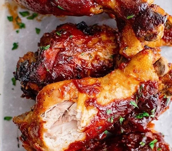 Slow Cooker BBQ Chicken Legs served on a plate with sauce and garnish