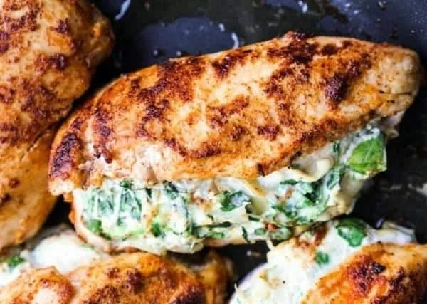 Oven baked Spinach Artichoke Stuffed Chicken breasts on a plate