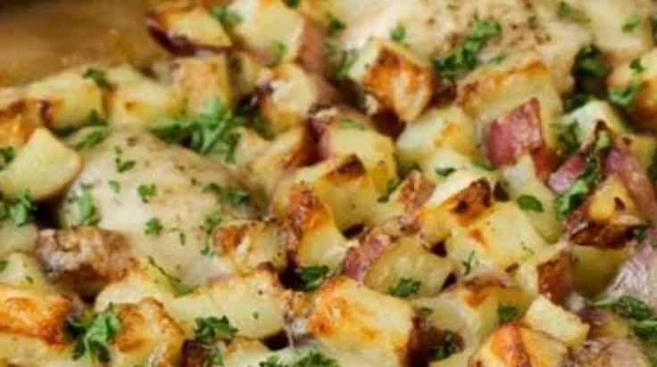 Delicious Chicken Potato Bake topped with herbs and cheese